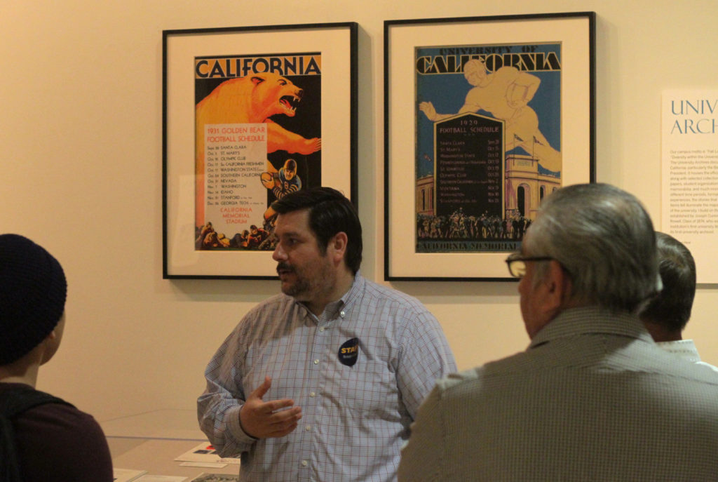 Curator discusses materials with patrons