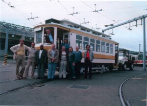 Men standing in front of trolly.