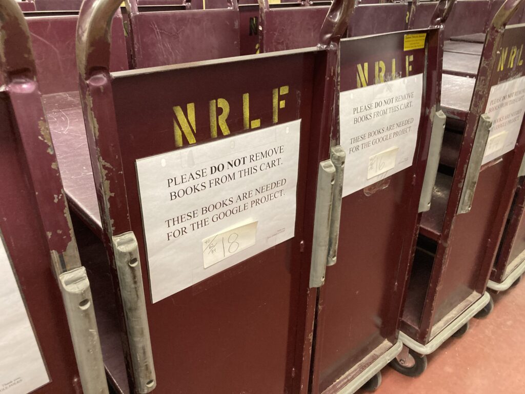 Row of book carts labeled NRLF