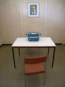 Interview room at Marienborn, the border of the former German Democratic Republic. Two chairs, a desk, and typewriter, now part of a museum exhibit. 