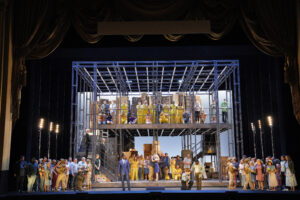 front view of stage, performance of opera Fidelio, with chorus and leads dressed as detainees and guards in a prison camp. San Francsico Opera, 2021