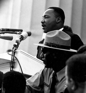 Martin Luther King, Jr., speaking at a podium at the March on Washington