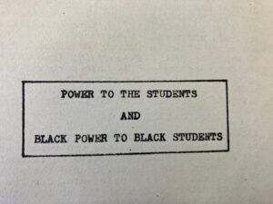 Close up of motto on the back of a pamphlet for the Black Student Union at Oakland Tech, in black & white