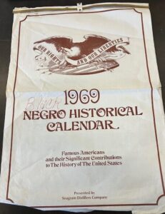 Large wall/desk calendar celebrating famous Americans and their achievements - with "Negro" crossed out and replaced by "Black"