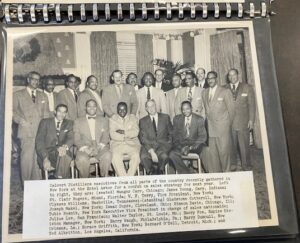 Page from a photo album showing a group of attendees at a Calvert Distillers gathering