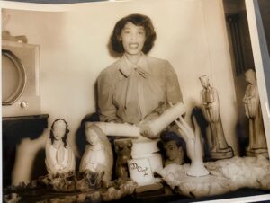 Sibeko-Kouate poses behind examples of her pottery